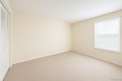 Unfurnished bedroom with carpet and a closet