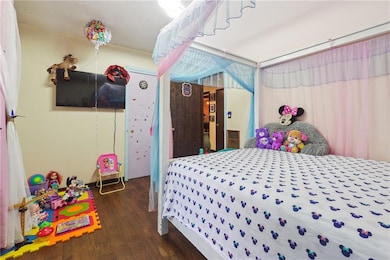 Bedroom featuring dark wood finished floors
