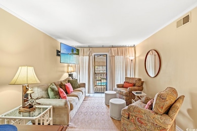 Living area featuring crown molding and wood finished floors