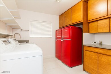 Laundry room with dual refrigerators, washer, drye