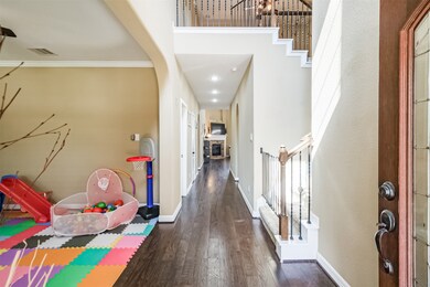 Two stories entryway opens to a formal living or formal dining on the left that could also be used as a home office, playroom or music room.