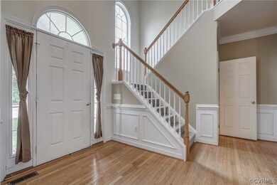 Foyer with Hardwood Floors, Wainscoting and Pallad