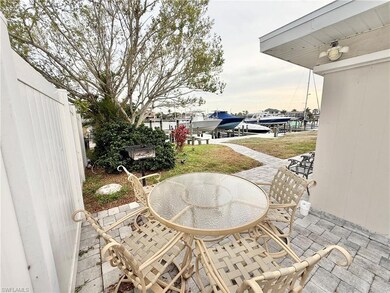 View of patio / terrace featuring boat lift, a boat dock, a water view, and outdoor dining area