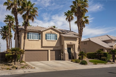 View of front of home featuring a garage, a tiled