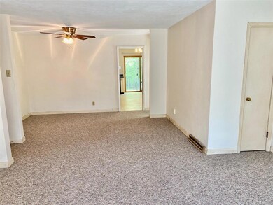 The living room flows into the open dining room and spacious kitchen to the rear of the home.