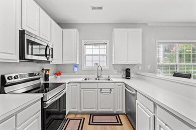 Kitchen featuring light wood-type flooring, stainl