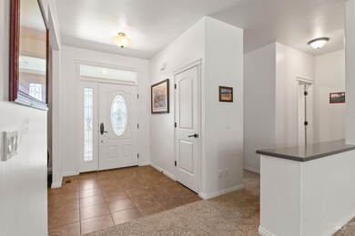 Entrance foyer with plenty of natural light and tile patterned flooring