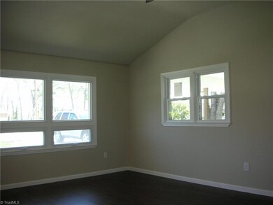 Living Room: Features include vinyl plank flooring for easy cleaning, 6 windows for lots of natural lighting, raised ceiling, a ceiling fan with light and fresh paint. The front entry door is to the left side.