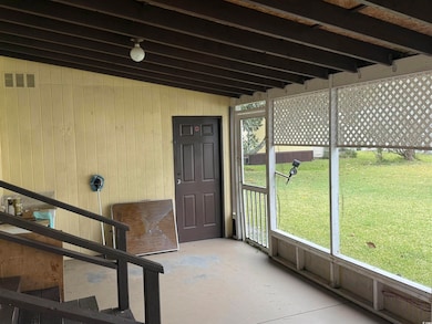 View of Screened in patio leading to workshop.