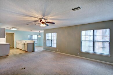 View from the living room into the kitchen and din