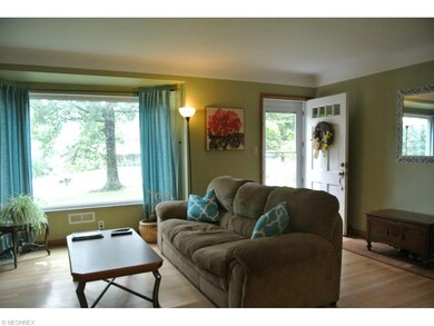 Welcoming Living Room has hardwood floor, coved ce