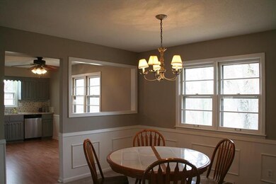 Dining room features wainscoting and lots of light
