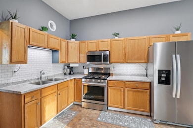 Kitchen with light stone counters, stainless steel