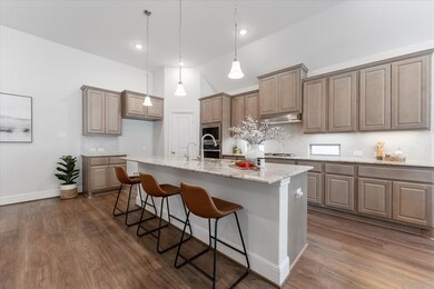 Be prepared to show off your culinary skills in this beautifully appointed kitchen featuring an oversized island with upgraded pendant lights above. You'll also find gorgeous granite countertops, tile backsplash, countertop windows & under-cabinet lights, sleek stainless steel appliances, a large pantry with a built-in spice rack and more.