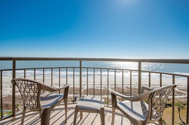 Balcony with view of water and beach