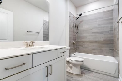 Full bathroom with vanity, toilet, and shower / tub combination