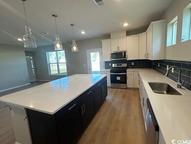 Kitchen with stainless steel appliances, sink, whi