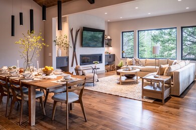 Living area with a fireplace, recessed lighting, wood finished floors, and visible vents