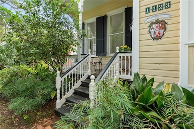 Doorway to property featuring covered porch