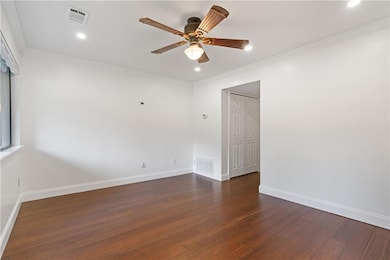 Living Room featuring a ceiling fan, dark wood-style floors, new ornamental molding, new recessed lighting and freshly painted.