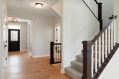 Spacious foyer with stunning hardwood floors
