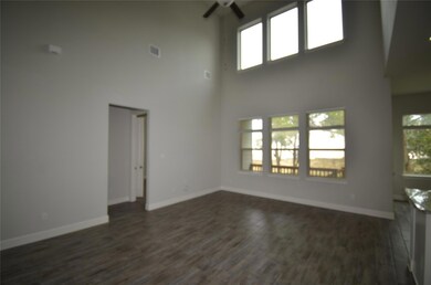 Unfurnished living room featuring ceiling fan, he