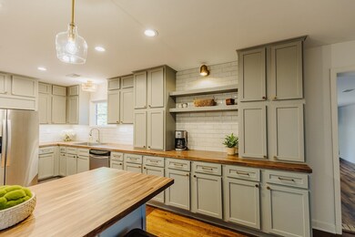 Kitchen featuring pendant lighting, stainless stee