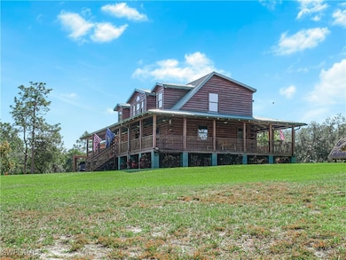 Rear view of house featuring a yard