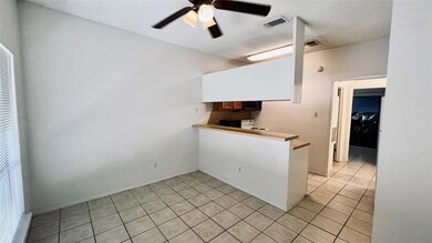 Kitchen featuring a ceiling fan, a textured ceili