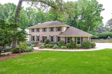 Colonial home with brick siding and roof with shingles