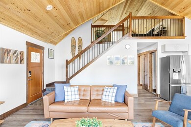 Living room featuring high vaulted ceiling, wood c