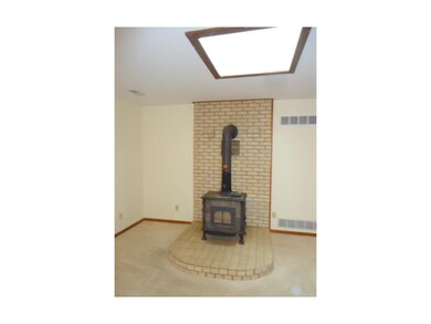 Living room with Wood Stove and skylight