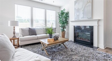 Living area with wood finished floors, a premium fireplace, and baseboards