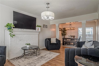 Living room with a chandelier, decorative columns,