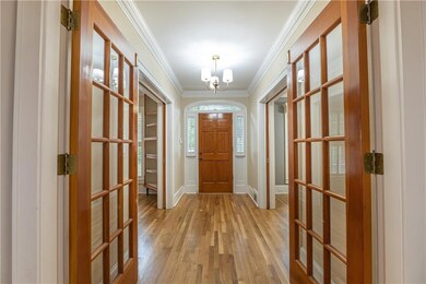 Step through the beautiful foyer with double glass doors into a home designed for both everyday comfort and elegant entertaining.