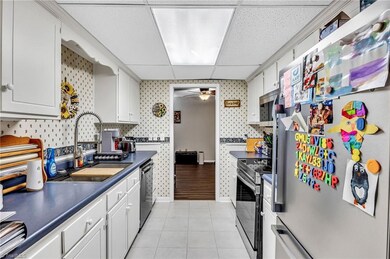 Galley kitchen with brand new appliances and farmhouse sink
