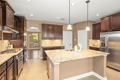 The heart of this home is this amazing kitchen.  It boasts a 5 burner gas stove top, two separate electric ovens that are essential for those special occasions when you might be baking pies in one oven and roasting a turkey in the other.  The built in microwave is conveniently located in the cabinet tower above the second oven. This very large island offers granite countertops, a breakfast bar, a dual stainless steel sink and a 2024 sprayer faucet.