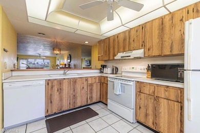 Kitchen featuring hanging light fixtures, sink, wh