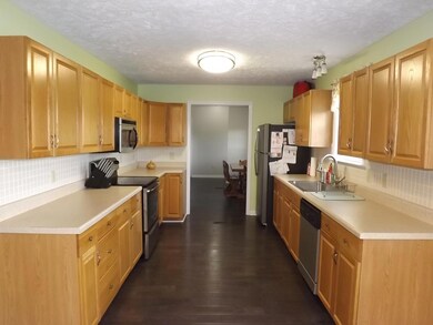 Spacious kitchen with beautiful cabinets, lots of counter-space and tile back-splash.
