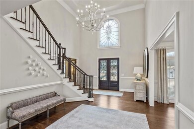 Foyer with plenty of natural light, crown molding,