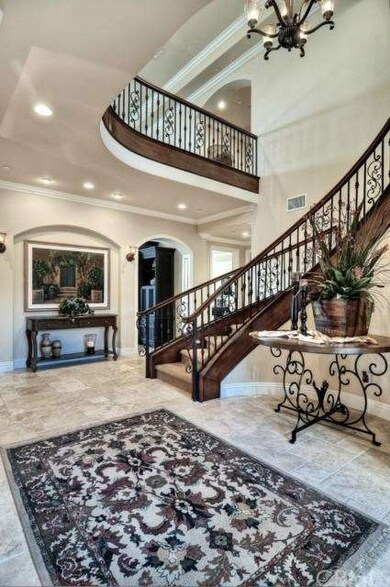 two-story high ENTRY FOYER with travertine floor, 