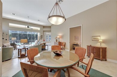 Dining space with light tile patterned floors, bas