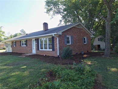 Natural area on right of home with lots of shade