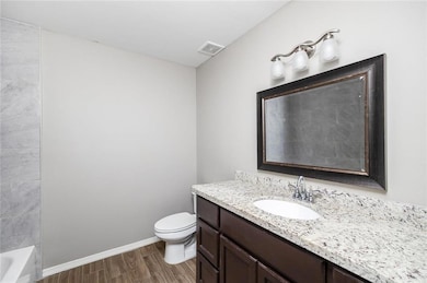 Bathroom featuring vanity and wood finished floors