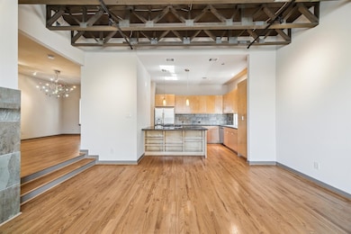 Modern open-concept living space features hardwood
