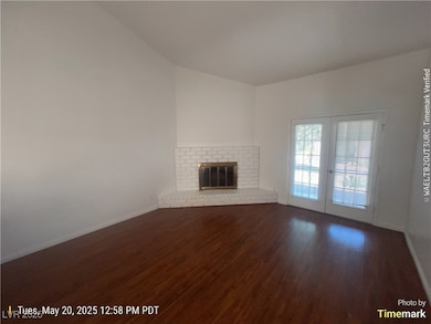 Unfurnished living room featuring wood finished fl