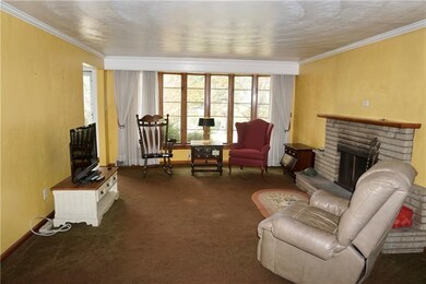 Large living room with bay window and fireplace