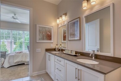Bathroom with tile patterned floors, vanity, and c