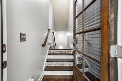 Staircase with baseboards and wood finished floors