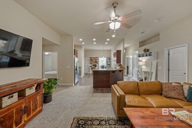 Carpeted living room with ceiling fan